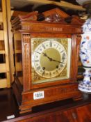 A wood cased architectural style mantel clock.