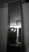 An oblong gilt framed mirror.