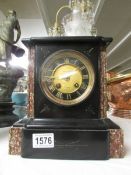 A black marble clock marked Usher & Son, Lincoln,.
