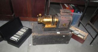 A Victorian magic lantern projector and 3 boxes of glass lantern slides,