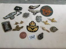A mixed lot of metal and cloth badges including German,.