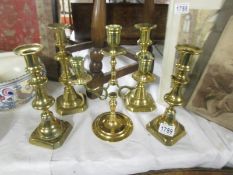 2 pairs of brass candlesticks and a brass candelabra.