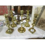 2 pairs of brass candlesticks and a brass candelabra.