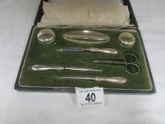 A cased silver plated manicure set.