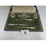 A cased silver plated manicure set.