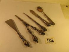 A pair of silver handled glove stretchers, a silver handled shoe horn, a silver handled button hook,