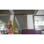 An oblong gilt framed mirror.