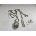 A silver locket on chain and a silver ingot on chain,