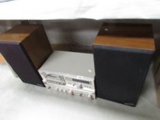 A Hitachi tape deck with speakers.