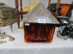 A Whitefriars style amber glass lamp shade with arts and crafts copper top.