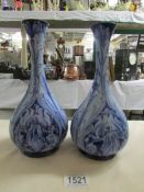 A pair of Jas. Macintyre & Co., Moorcroft Florian ware vases, (both have tiny chips to rims.