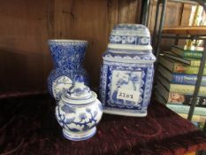 2 blue and white jars and a vase.