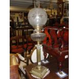 A brass Corinthian column oil lamp with Hinks burner and cut glass font.