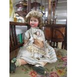 A bisque headed doll marked SH, PB in star, 1909 - 7, Germany and a smaller doll.