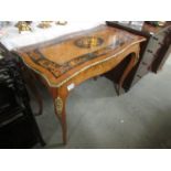 A marquetry centre table with black panels.