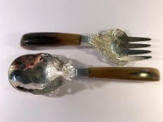 A pair of salad servers with solid horn handles (possibly rhino horn).