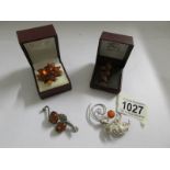 Four amber brooches.