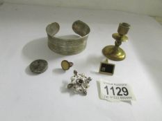 A silver brooch, a engraved bracelet etc.