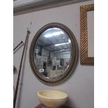 An oval framed mirror.