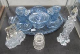 A blue glass trinket set and 3 perfume bottles.