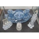 A blue glass trinket set and 3 perfume bottles.