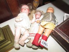 A porcelain doll marked Revalo, Germany and 2 other dolls.