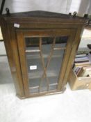 A small astragal glazed corner cabinet.