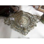 An ornate heavy brass tray.