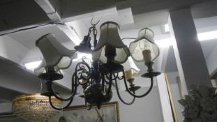 A 6 lamp brass ceiling lamp.