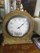 A French mantel clock with snake skin covering.