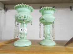 A pair of 19th century green glass lustres.