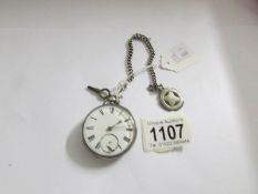 A silver pocket watch with silver Albert and chain, in working order but dial needs attention.