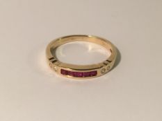 A 9ct gold diamond and ruby band ring,.