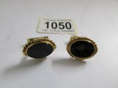 A superb pair of 9ct gold cuff links set onyx.