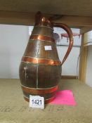 An old coopered jug bound in copper.