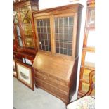 An oak lead glazed bureau bookcase.