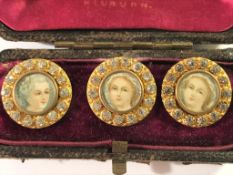 A cased set of 3 Victorian decorative buttons with miniature portraits inset.