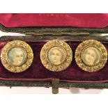 A cased set of 3 Victorian decorative buttons with miniature portraits inset.