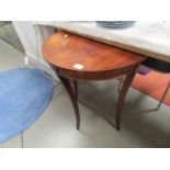 A mahogany D shaped table.