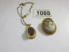 An amethyst pendant and a cameo brooch.