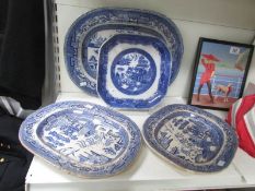 3 blue and white willow pattern meat platters and a plate.