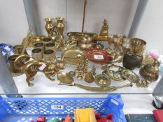 A mixed lot of brass ware including goblets, bells, miniature candlesticks.