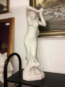An indoor statue of a lady.