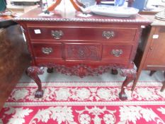 A carved mahogany chest of drawers.