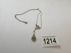 A good old platinum coloured pendant, not marked.