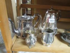 A silver plate tea pot, coffee pot and 2 cream jugs.
