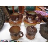 2 stone ware jugs, a tankard and a tobacco jar.