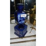 An old blue vase on stand.