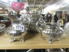 A silver plate teapot, milk jug and sugar bowl.