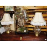 A pair of glass table lamps with shades.